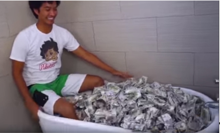 Man sitting in a bathtub filled with cash