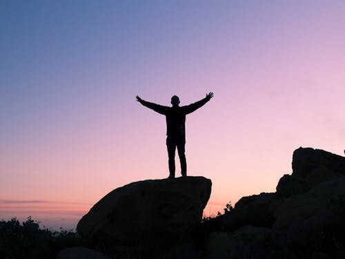 Jubilant man on top of a mountain